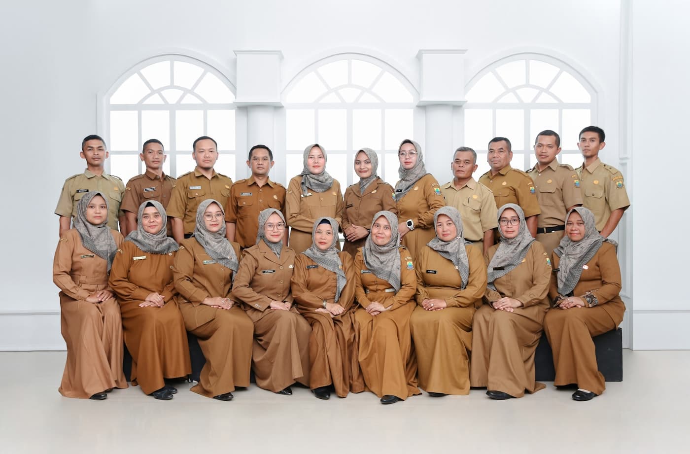 Office team posing together in matching uniforms