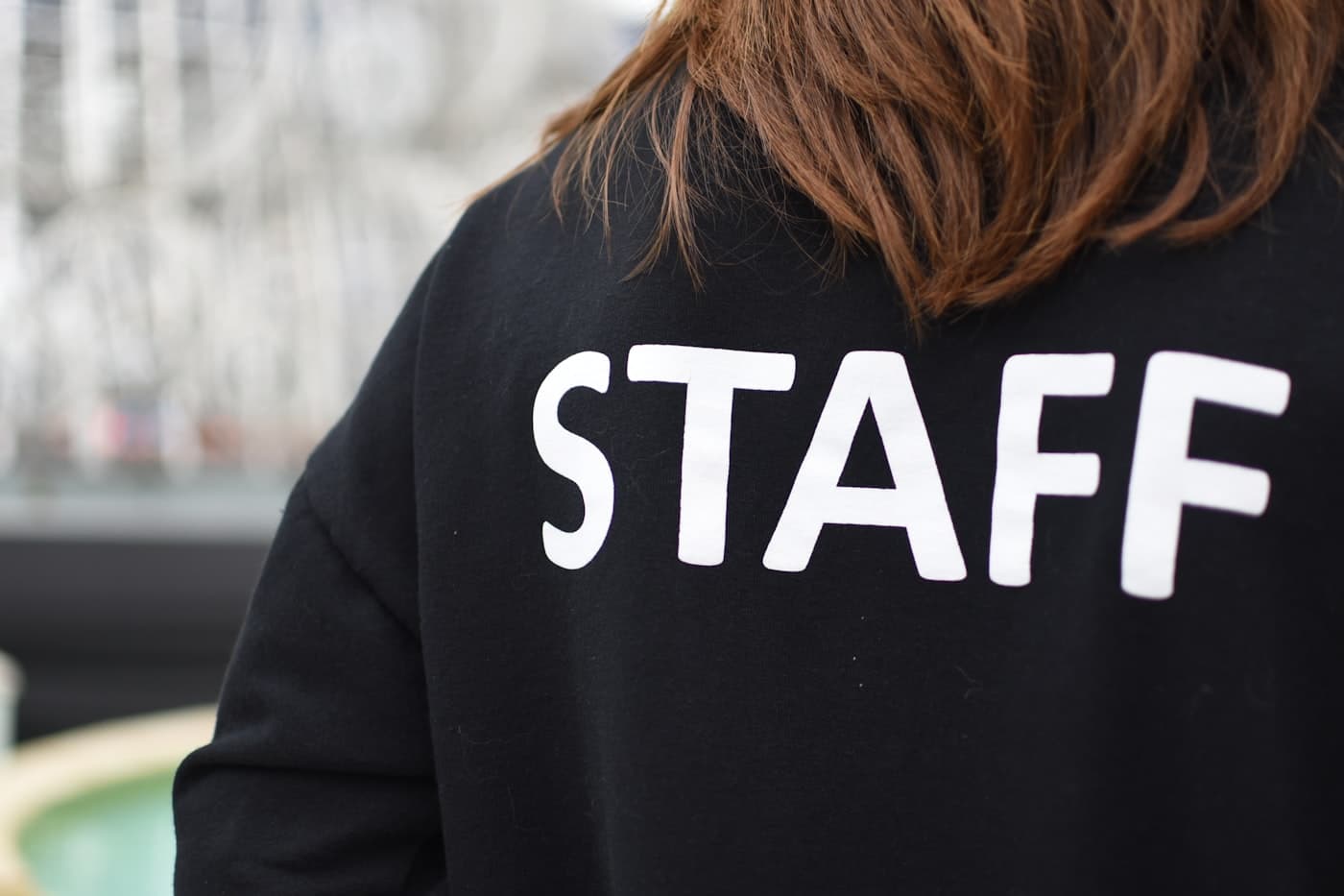 Close-up of a staff member's branded uniform shirt