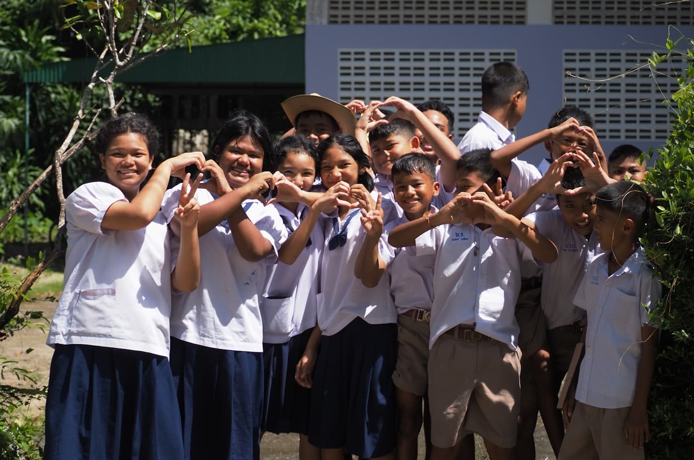 Students in school uniforms posing together outdoors