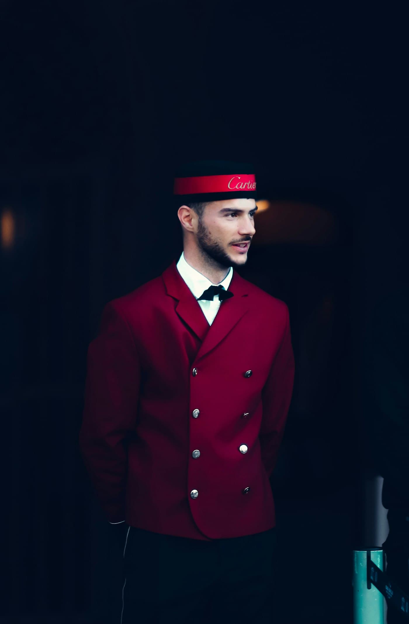 Hotel doorman in a formal red uniform