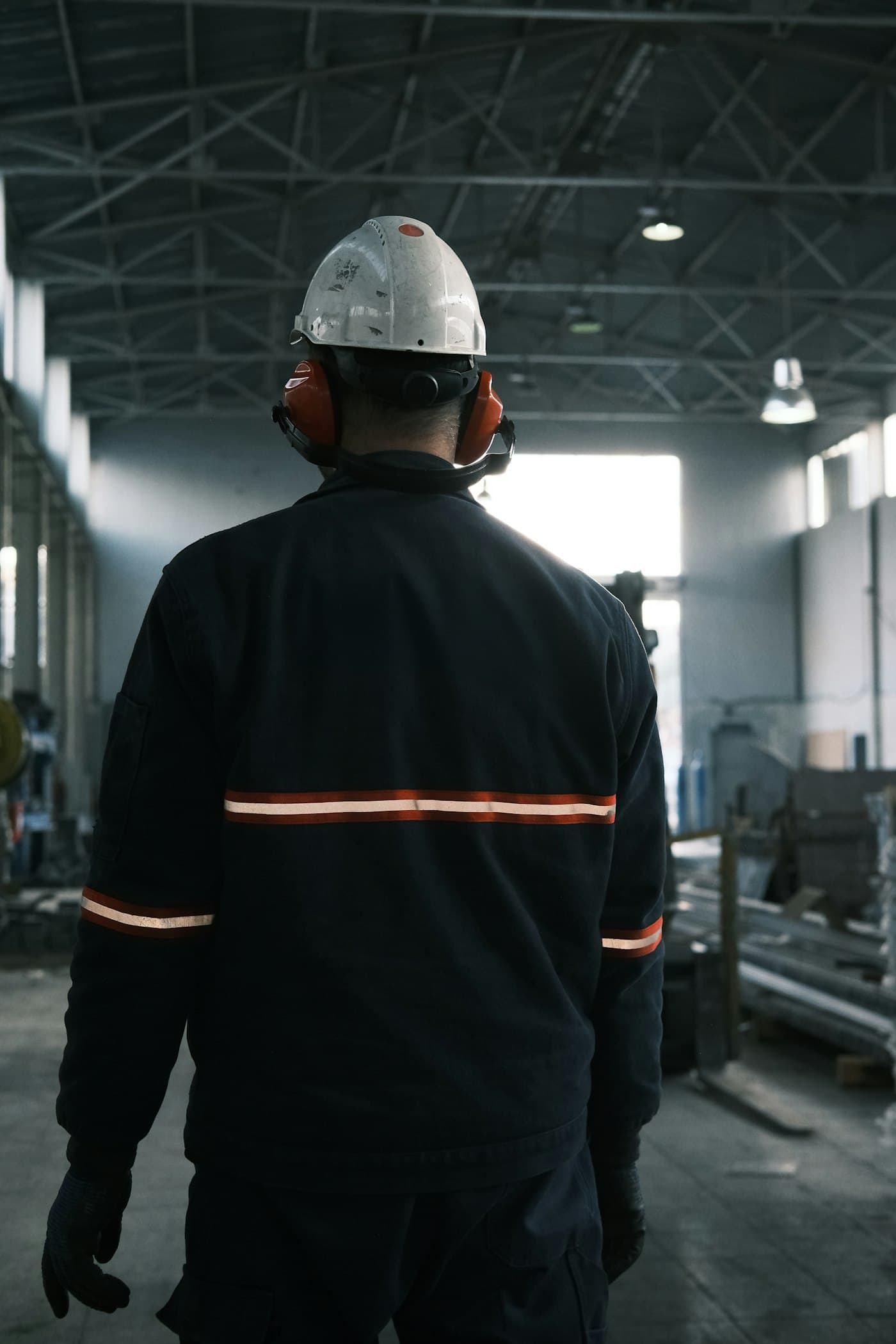 Factory worker in a hard hat and reflective coveralls