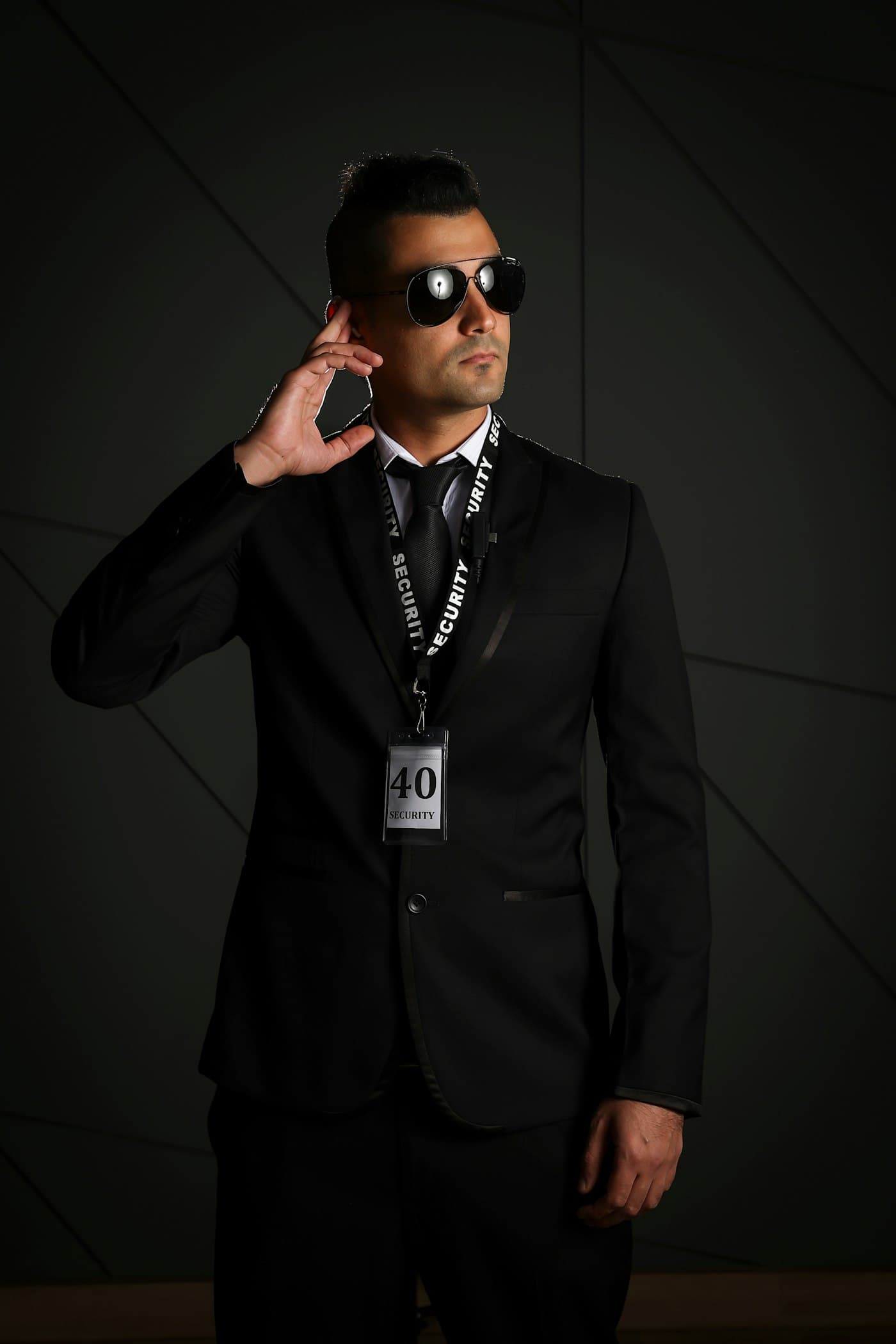 Security professional in a formal suit with a security badge